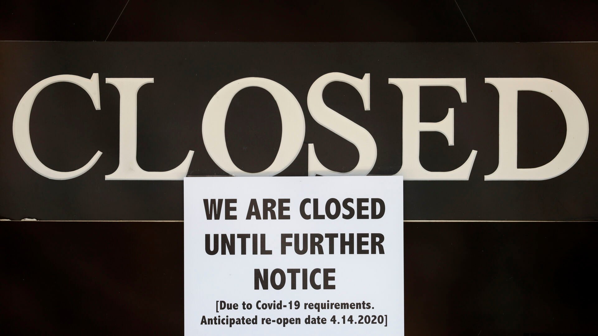<p>In this April 2, 2020 file photo, a notice of closure is posted at The Great Frame Up in Grosse Pointe Woods, Mich.&nbsp;</p>